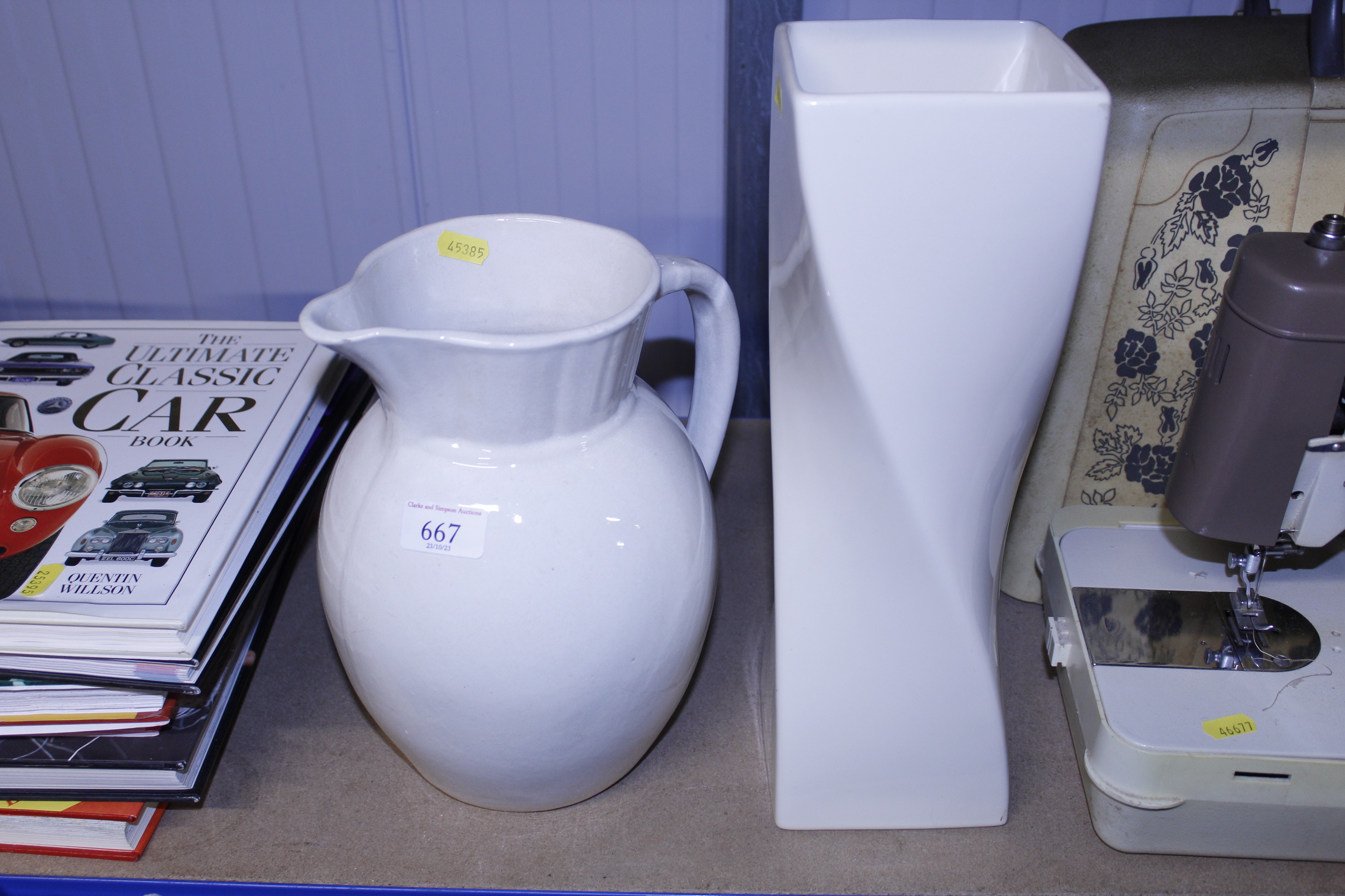 A white glazed toilet jug; and a white glazed mode
