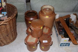 A quantity of stone glazed storage jars