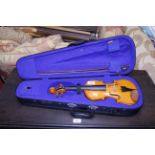 A cased child's violin and bow