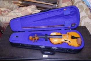 A cased child's violin and bow