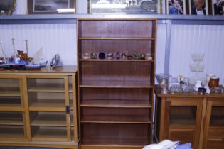 A teak open fronted bookcase