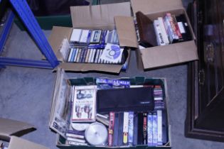 A box of miscellaneous DVD's, tapes, cassettes etc