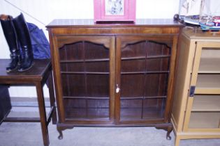 A mahogany china display cabinet on cabriole suppo