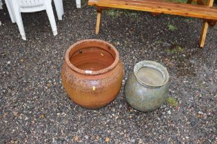 A large terracotta pot and a smaller earthenware p