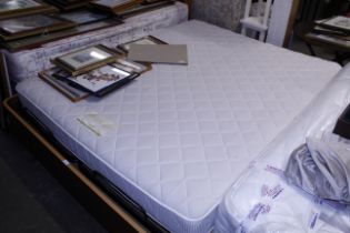 A modern king size bed complete with mattress