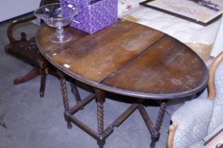 An oak barley twist gate leg dining table