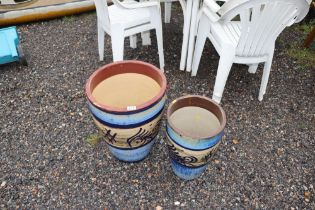 Two graduated glazed earthenware garden pots