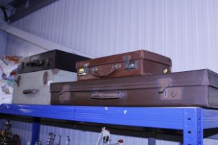 Two leather covered vintage suitcases and two vint