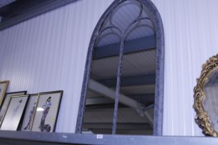 An arched window shaped mirror