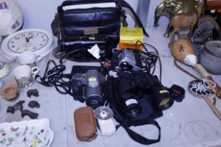 A pair of binoculars, a Panasonic camcorder, vario