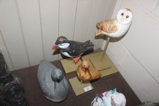 A Helmsdale pottery model duck; and three wooden m