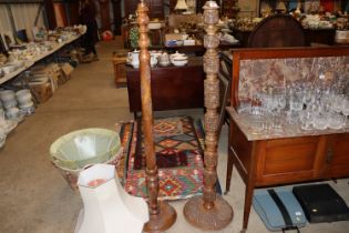 Two carved hardwood standard lamps with four shade