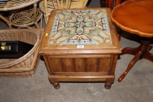 An oak step commode with needlework upholstery