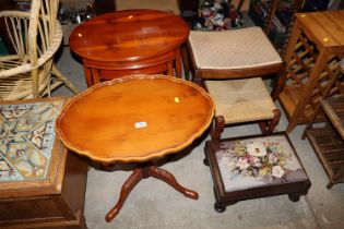 A nest of three reproduction yew wood tables; pede