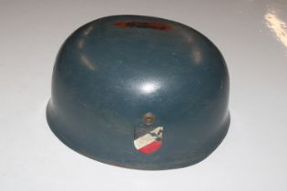 A German paratroopers helmet with later de-cals