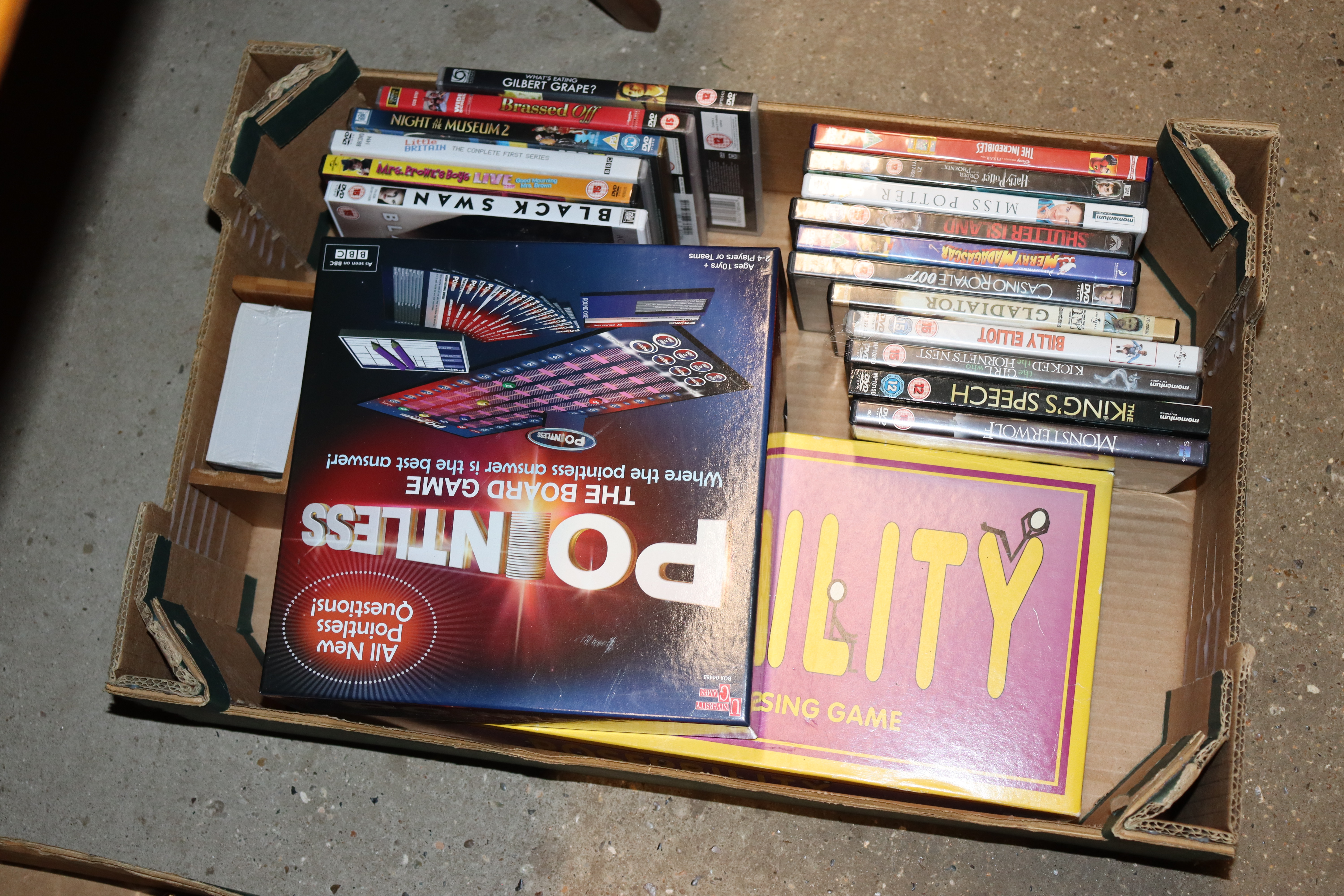 A box containing DVDs and games