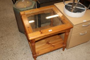 A pine and glass topped coffee table