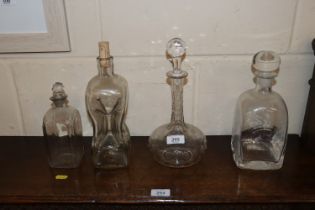 Four glass decanters, one lacking stopper