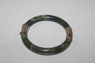 A vintage Chinese hardstone and white metal bangle