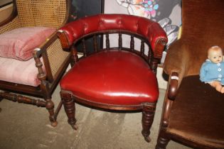A red leather upholstered Captains chair
