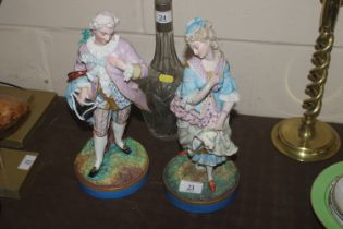 A pair of porcelain figures marked A.M. to base