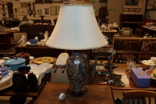 A floral decorated baluster table lamp and shade
