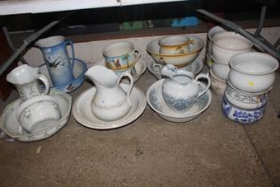 A large collection of various wash jugs and bowls