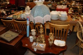 A gilt table lamp and shade; pineapple ornaments;