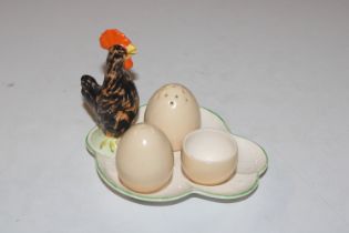 A cruet set in the form of a chicken and eggs