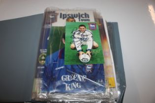 A folder of various football programmes, most with