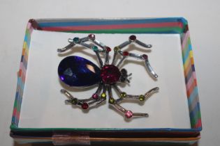 A multi coloured stone set brooch in the form of a