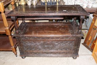 A carved oak monks bench