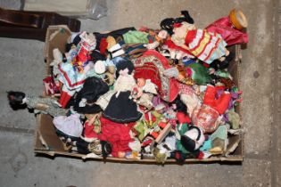 A box of various souvenir and other dolls