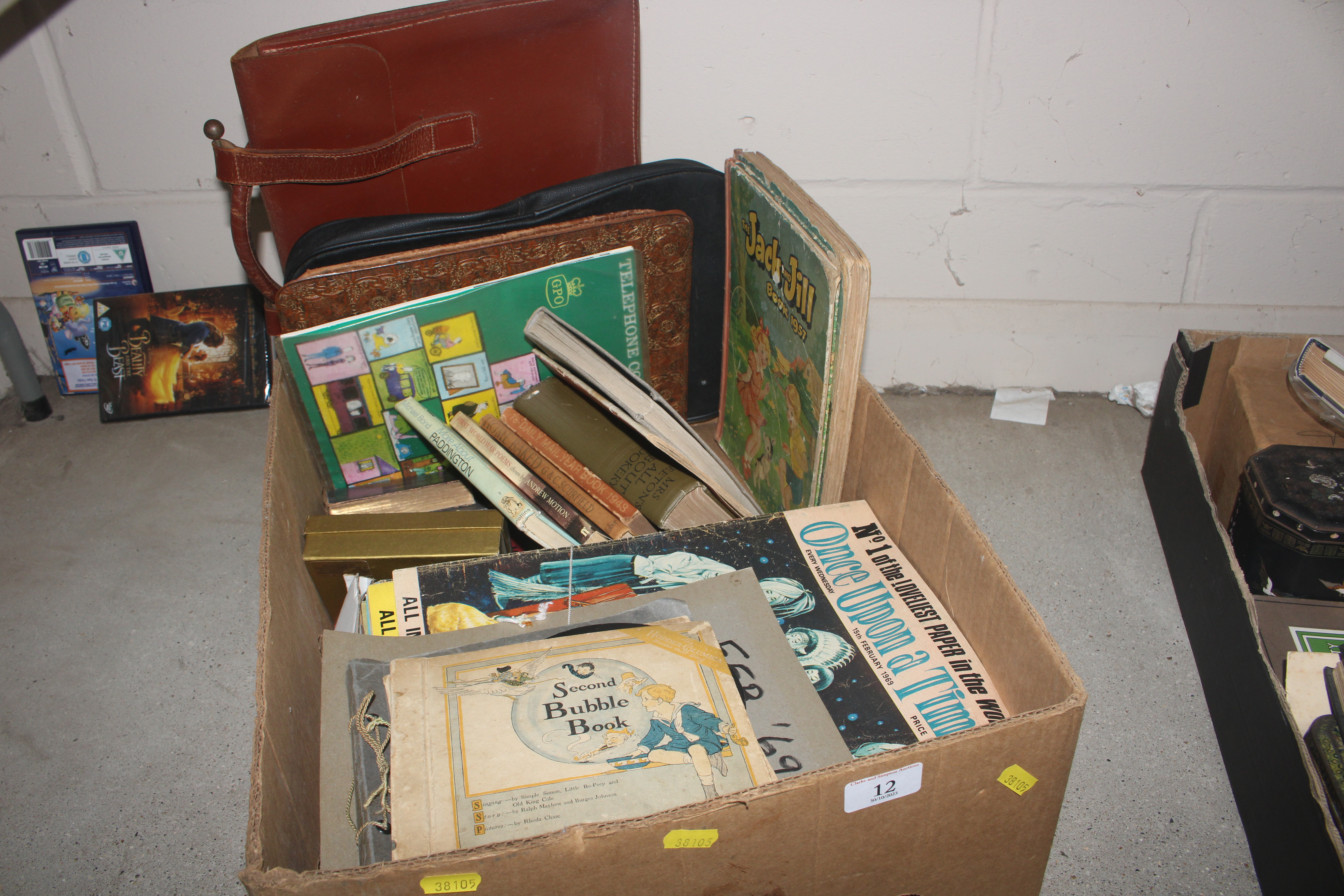 A box containing magazines, books, records, bag et