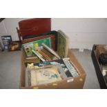 A box containing magazines, books, records, bag et