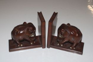 A pair of carved hardwood book ends in the form of