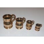 A graduated set of four bell metal measures and a