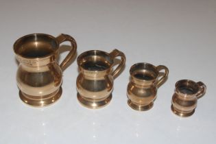 A graduated set of four bell metal measures and a