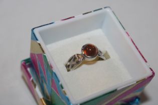 A Celtic style Sterling silver and amber ring, siz