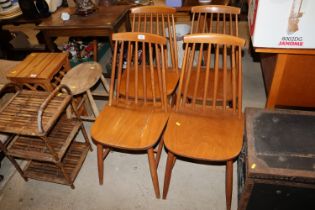 A set of four Ercol style stick back chairs