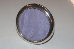 A circular silver photo frame AF