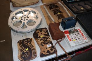 A decorative mirror made from a film reel, two box