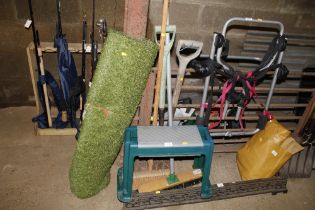 A garden kneeler and collection of garden tools