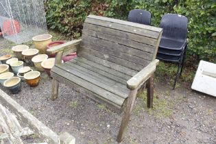 A slatted wooden garden bench