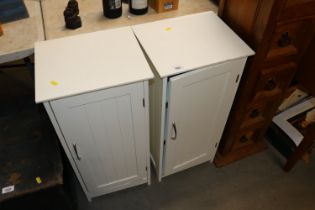 A pair of white bedside cupboards