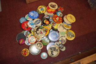 A box of various vintage badges