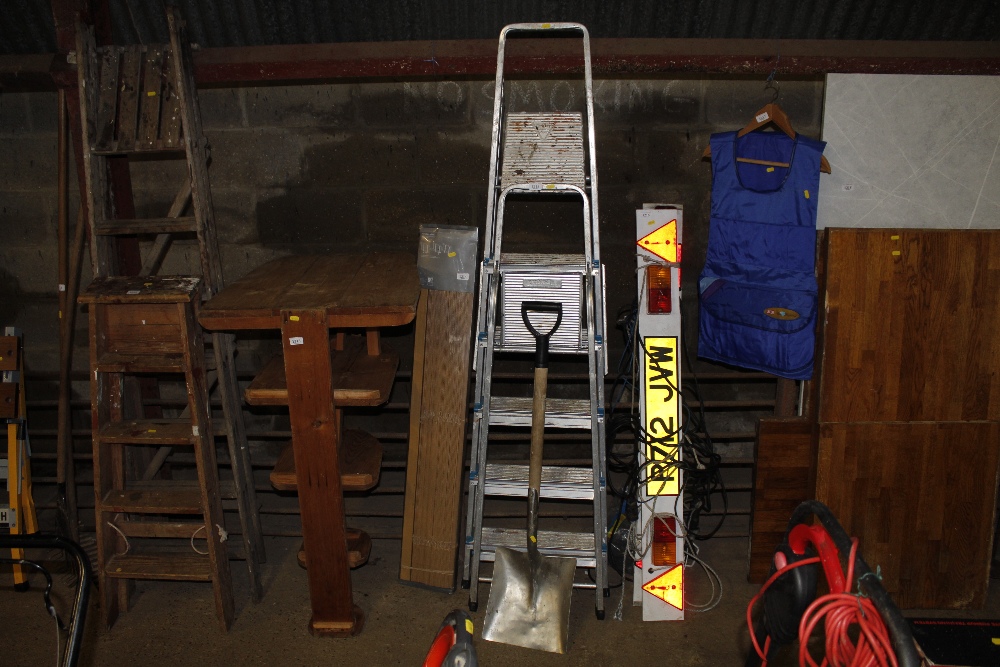 Two aluminium folding step ladders and a shovel