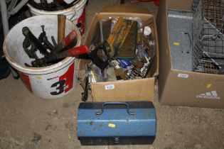 A box containing a metal tool box, various tools a