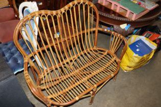 A circa 1960s two seater cane settee