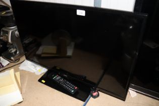 A Logik flat screen television with remote control